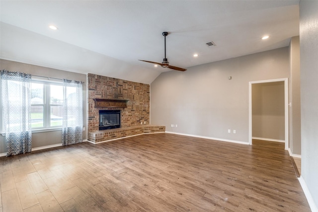 617 Ruth Dr, Kennedale, TX 76060 - unfurnished living room with a ceiling fan, vaulted ceiling, wood finished floors, a brick fireplace, and recessed lighting