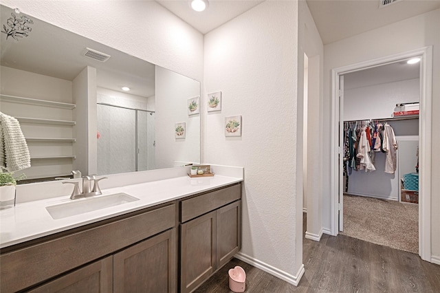 505 Cistern Way, Royse City, TX 75189 - full bath with wood finished floors, a spacious closet, a shower stall, vanity, and a textured wall