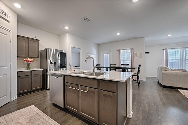 505 Cistern Way, Royse City, TX 75189 - kitchen featuring appliances with stainless steel finishes, dark wood-style flooring, light countertops, open floor plan, and dark brown cabinets
