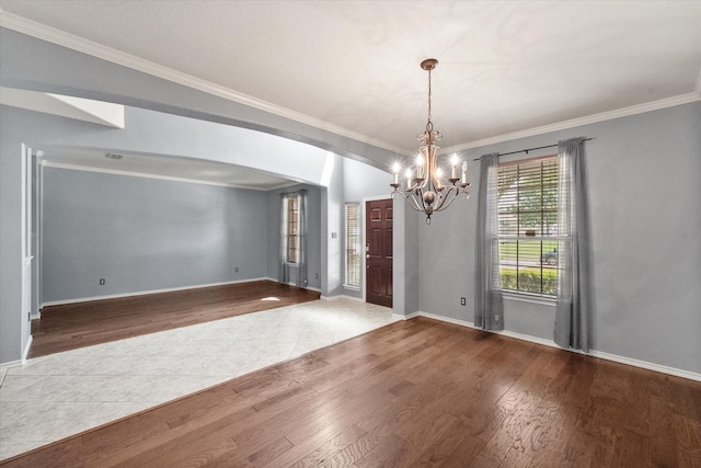 9324 Shadowfax Dr, Arlington, TX 76002 - empty room featuring a chandelier, crown molding, wood finished floors, and arched walkways
