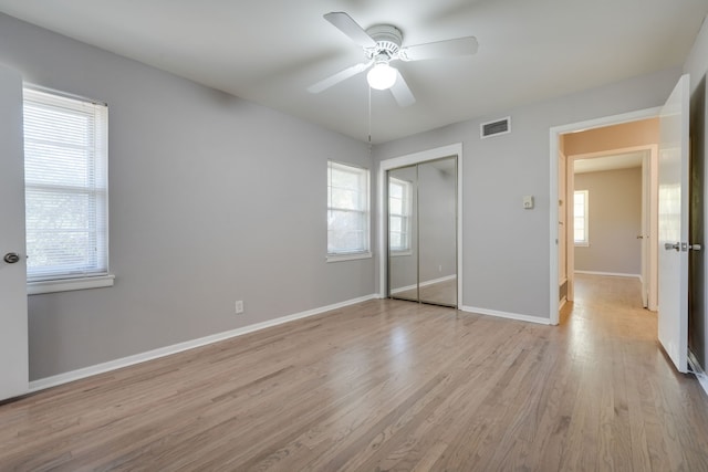 2442 Oates Dr, Dallas, TX 75228 - unfurnished bedroom featuring light wood-type flooring, a closet, and a ceiling fan