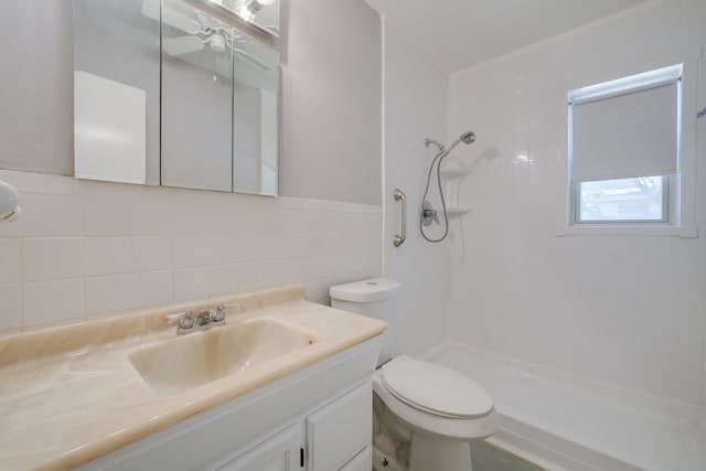 2442 Oates Dr, Dallas, TX 75228 - bathroom with tile walls, vanity, a tile shower, ceiling fan, and tasteful backsplash