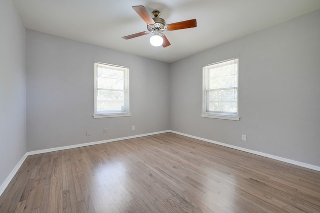 2442 Oates Dr, Dallas, TX 75228 - spare room with healthy amount of natural light, wood finished floors, and ceiling fan