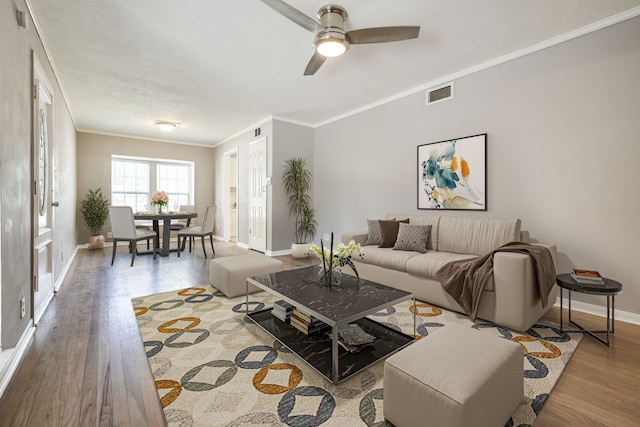 2442 Oates Dr, Dallas, TX 75228 - living room featuring wood finished floors, ornamental molding, and a ceiling fan