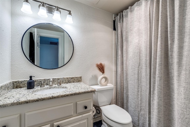 3208 Cole Ave Unit 1110, Dallas, TX 75204 - bathroom with vanity, a textured wall, and a shower with curtain