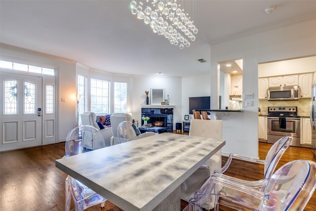 3208 Cole Ave Unit 1110, Dallas, TX 75204 - dining area with crown molding, wood finished floors, and a fireplace