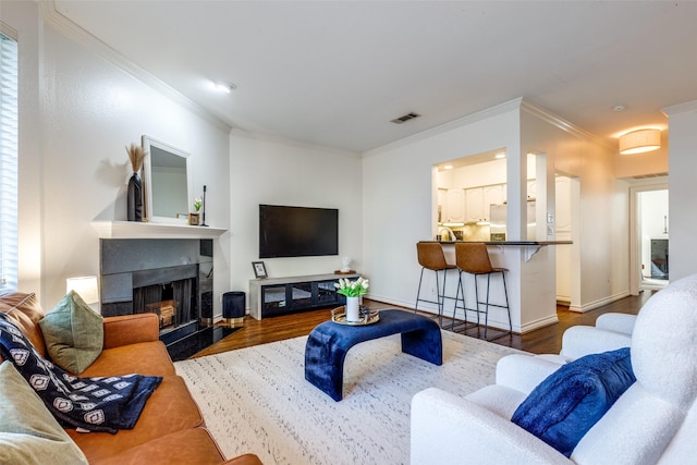 3208 Cole Ave Unit 1110, Dallas, TX 75204 - living room featuring dark wood-type flooring, crown molding, and a fireplace with raised hearth