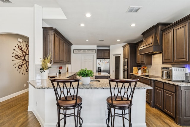 1344 Mountain View Ln, Kennedale, TX 76060 - kitchen featuring stainless steel appliances, a peninsula, dark brown cabinetry, and recessed lighting