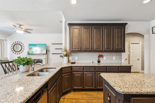 1344 Mountain View Ln, Kennedale, TX 76060 - kitchen with arched walkways, a ceiling fan, dark brown cabinets, light stone countertops, and recessed lighting