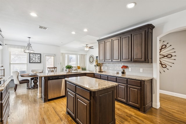 1344 Mountain View Ln, Kennedale, TX 76060 - kitchen with stainless steel dishwasher, dark brown cabinets, backsplash, recessed lighting, and light wood-type flooring