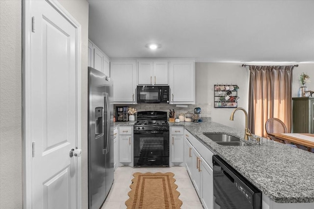 2525 Bunkerton Dr, Fort Worth, TX 76179 - kitchen with black appliances, a peninsula, white cabinets, and light tile patterned floors