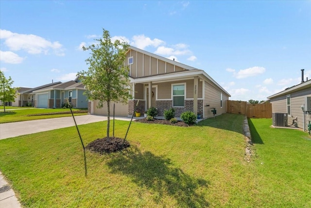 2525 Bunkerton Dr, Fort Worth, TX 76179 - view of front of house with concrete driveway, board and batten siding, brick siding, an attached garage, and covered porch