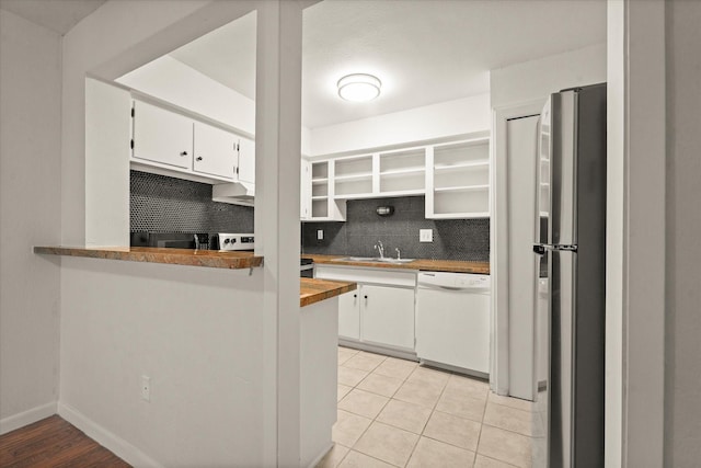 5305 Fleetwood Oaks Dr Unit 274, Dallas, TX 75235 - kitchen with white dishwasher, backsplash, white cabinetry, open shelves, and freestanding refrigerator