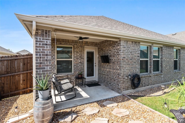 702 Stampede Ln, Princeton, TX 75407 - entrance to property featuring a ceiling fan, brick siding, a shingled roof, and a patio