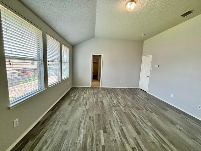 150 Wandering Dr, Forney, TX 75126 - unfurnished room with wood finished floors, a textured ceiling, and lofted ceiling