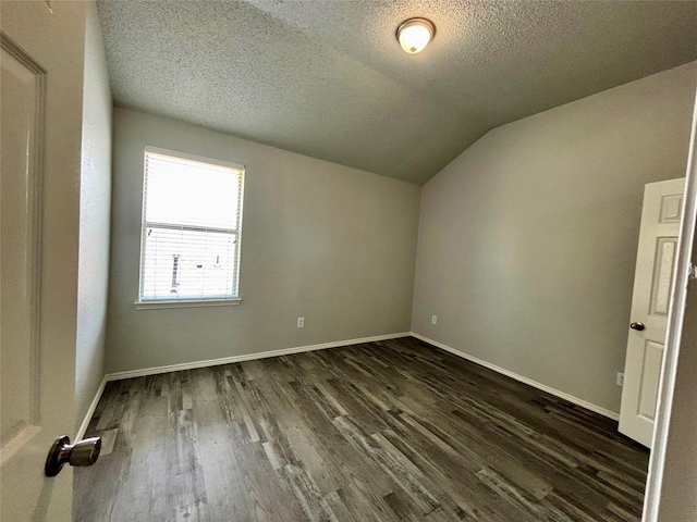 150 Wandering Dr, Forney, TX 75126 - additional living space with dark wood-style floors, vaulted ceiling, and a textured ceiling