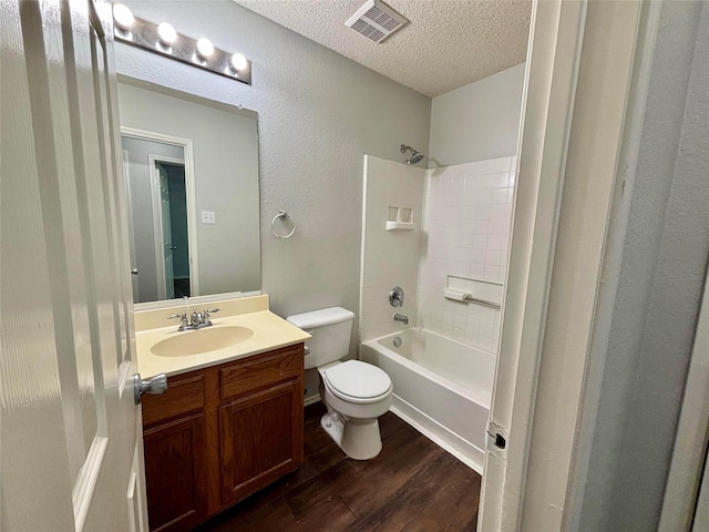 150 Wandering Dr, Forney, TX 75126 - bathroom featuring wood finished floors, a textured ceiling, vanity, shower / bathtub combination, and a textured wall