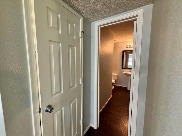 150 Wandering Dr, Forney, TX 75126 - hallway featuring a textured ceiling and dark wood-style flooring