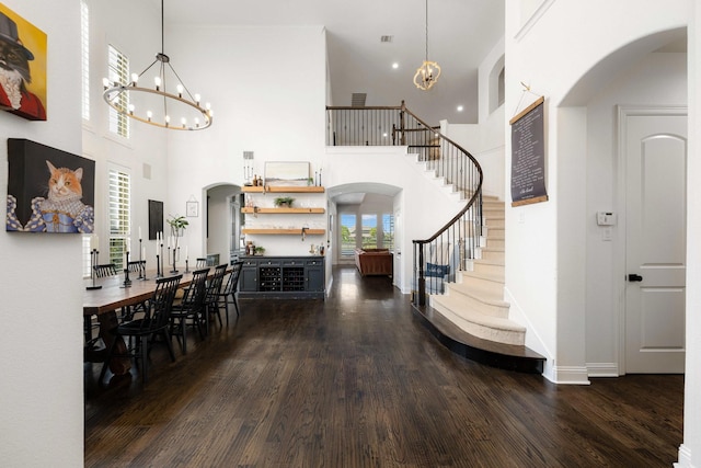 2223 Galloway Blvd, Trophy Club, TX 76262 - foyer with a chandelier, arched walkways, wood finished floors, stairway, and a towering ceiling