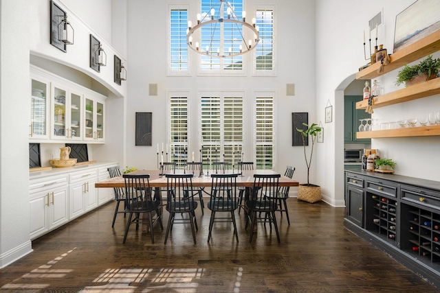 2223 Galloway Blvd, Trophy Club, TX 76262 - dining space featuring a high ceiling, dark wood-style floors, arched walkways, and a chandelier