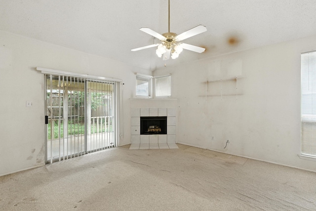 5004 Lodgepole Ln, Fort Worth, TX 76137 - unfurnished living room with a tile fireplace, carpet floors, and ceiling fan