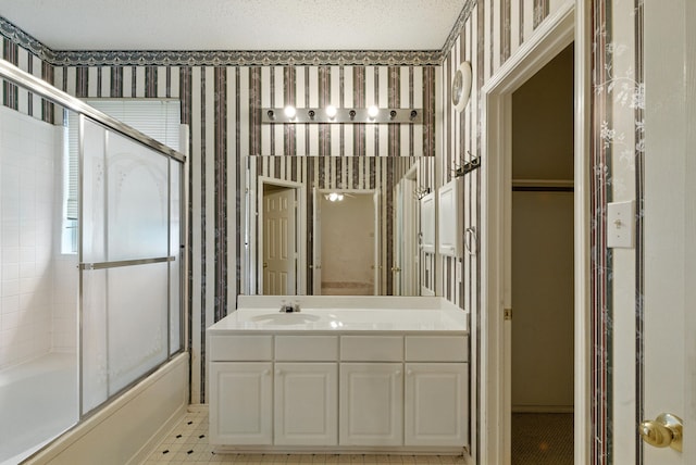 5004 Lodgepole Ln, Fort Worth, TX 76137 - bathroom with wallpapered walls, vanity, and shower / bath combination with glass door