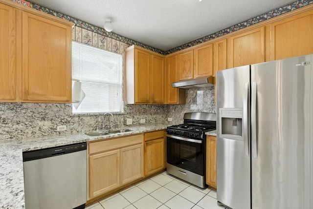 5004 Lodgepole Ln, Fort Worth, TX 76137 - kitchen with appliances with stainless steel finishes, under cabinet range hood, backsplash, light tile patterned flooring, and light stone countertops