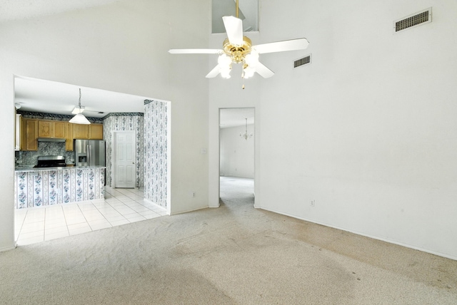 5004 Lodgepole Ln, Fort Worth, TX 76137 - unfurnished living room with light colored carpet, a high ceiling, a ceiling fan, and light tile patterned flooring