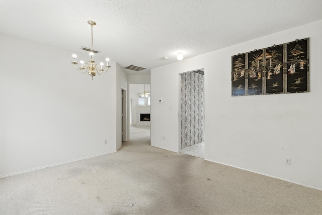 5004 Lodgepole Ln, Fort Worth, TX 76137 - empty room featuring a chandelier, carpet floors, and a textured ceiling