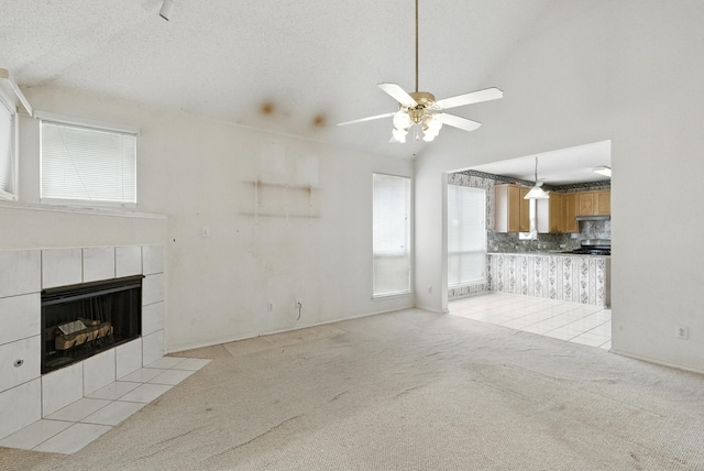 5004 Lodgepole Ln, Fort Worth, TX 76137 - unfurnished living room featuring light colored carpet, healthy amount of natural light, a fireplace, ceiling fan, and vaulted ceiling