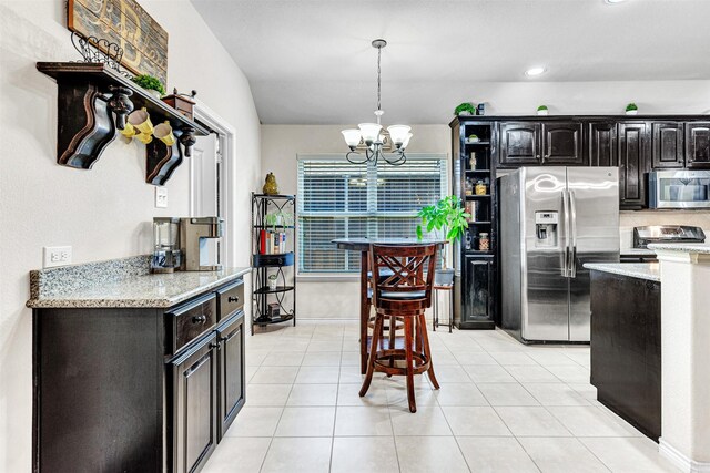 1402 White Water Ln, Rockwall, TX 75087 - kitchen featuring appliances with stainless steel finishes, a chandelier, light stone counters, pendant lighting, and open shelves