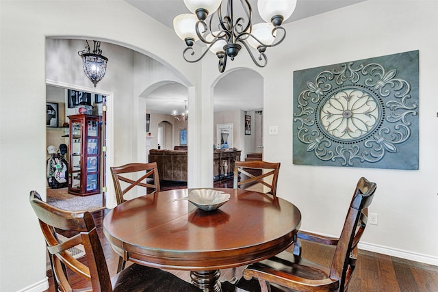 1402 White Water Ln, Rockwall, TX 75087 - dining space featuring arched walkways, a chandelier, and dark wood-type flooring