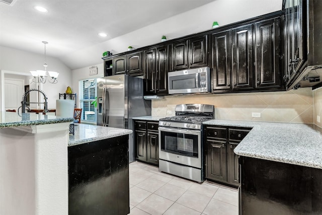 1402 White Water Ln, Rockwall, TX 75087 - kitchen featuring stainless steel appliances, dark cabinets, lofted ceiling, backsplash, and a chandelier