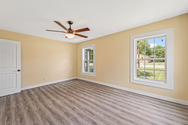 690 S Fifth Ave, Stephenville, TX 76401 - spare room with healthy amount of natural light, wood finished floors, and ceiling fan
