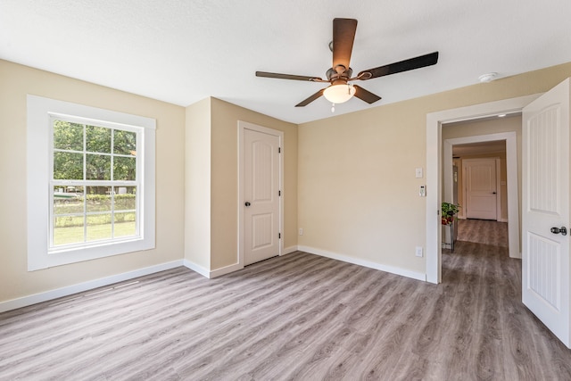 690 S Fifth Ave, Stephenville, TX 76401 - empty room featuring wood finished floors, a smoke detector, and a ceiling fan
