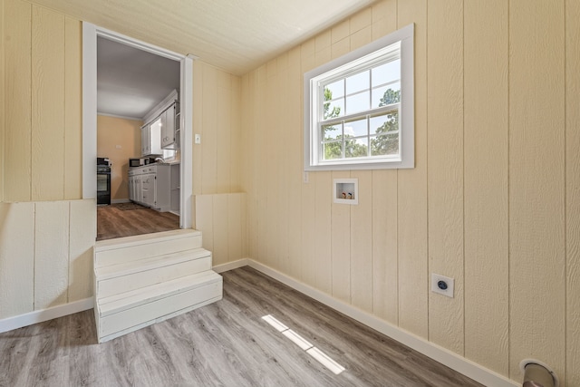 690 S Fifth Ave, Stephenville, TX 76401 - laundry room featuring electric dryer hookup, wood finished floors, and washer hookup
