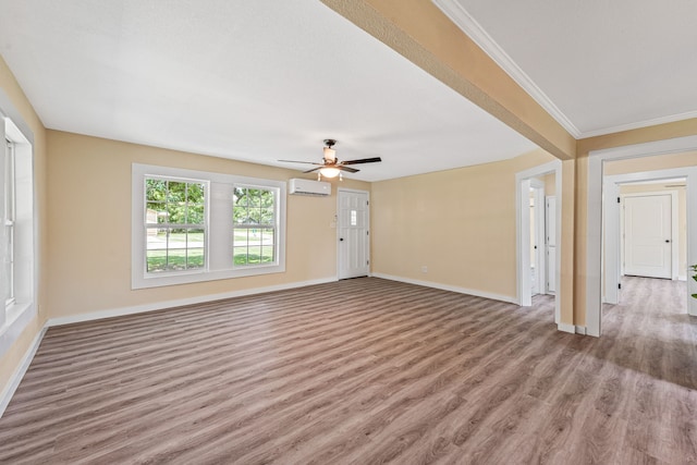 690 S Fifth Ave, Stephenville, TX 76401 - unfurnished living room with wood finished floors, a wall mounted air conditioner, ceiling fan, and ornamental molding