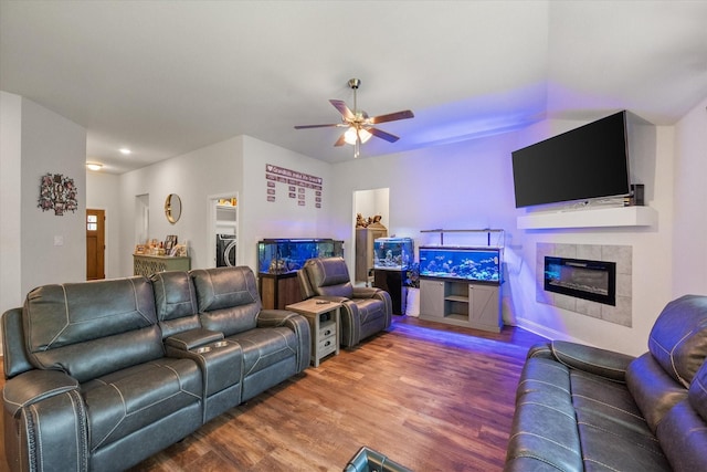 101 Paytons Way, Corsicana, TX 75110 - living room featuring wood finished floors, a ceiling fan, a fireplace, and washer / dryer