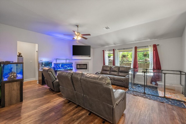 101 Paytons Way, Corsicana, TX 75110 - living room featuring wood finished floors, ceiling fan, vaulted ceiling, and a tiled fireplace