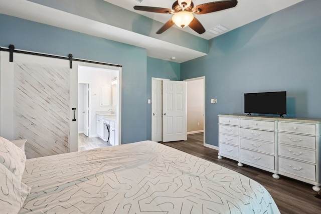 104 Northfield Cir, Hickory Creek, TX 75065 - bedroom with dark wood-style flooring, a barn door, a ceiling fan, and ensuite bathroom
