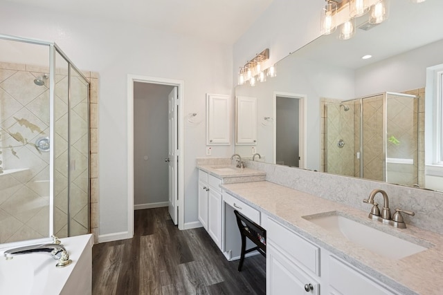 104 Northfield Cir, Hickory Creek, TX 75065 - bathroom with a stall shower, wood finished floors, double vanity, and a bath