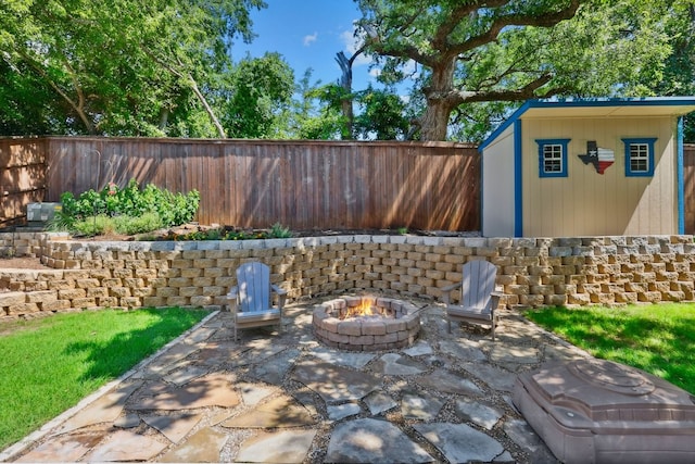 104 Northfield Cir, Hickory Creek, TX 75065 - fenced backyard with a patio, an outdoor fire pit, and a storage shed