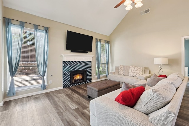 104 Northfield Cir, Hickory Creek, TX 75065 - living area featuring plenty of natural light, wood finished floors, high vaulted ceiling, a tile fireplace, and a ceiling fan