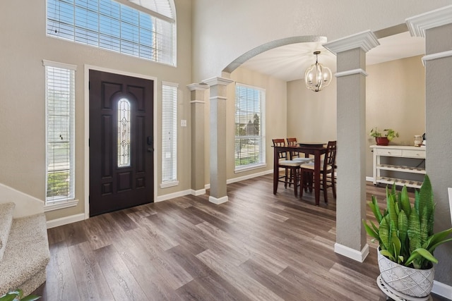 104 Northfield Cir, Hickory Creek, TX 75065 - foyer with wood finished floors, arched walkways, a chandelier, decorative columns, and a high ceiling