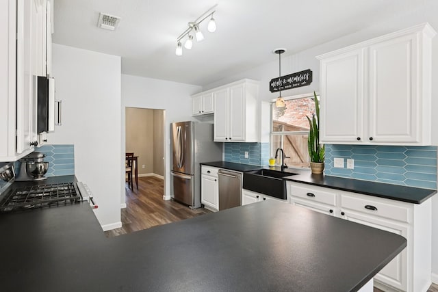 104 Northfield Cir, Hickory Creek, TX 75065 - kitchen featuring dark countertops, stainless steel appliances, and white cabinetry
