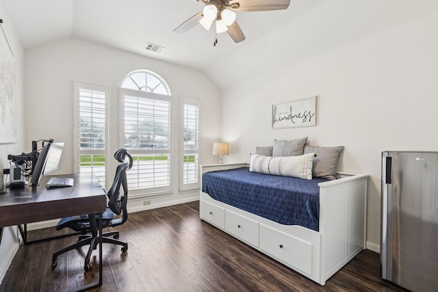 7716 Glenoaks Dr, Frisco, TX 75034 - bedroom with vaulted ceiling, multiple windows, dark wood-style floors, an office area, and freestanding refrigerator