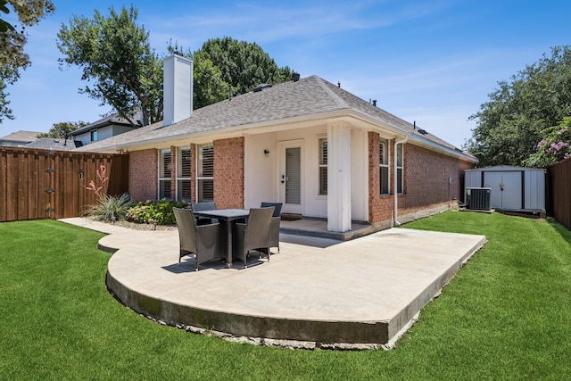 7716 Glenoaks Dr, Frisco, TX 75034 - rear view of house with brick siding, a patio area, a storage unit, a chimney, and a fenced backyard