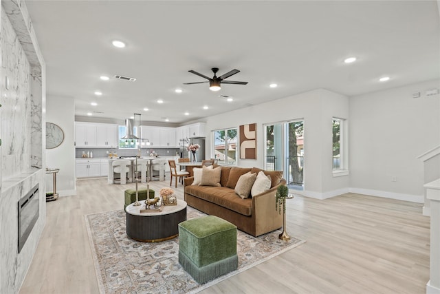 5115 Hohen Ave, Dallas, TX 75215 - living room featuring a high end fireplace, ceiling fan, healthy amount of natural light, light wood-style flooring, and recessed lighting