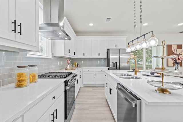 5115 Hohen Ave, Dallas, TX 75215 - kitchen with wall chimney range hood, stainless steel appliances, an island with sink, plenty of natural light, and recessed lighting