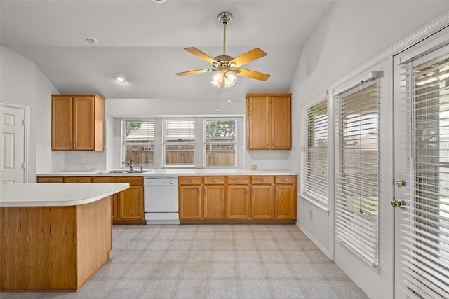8709 Hartford Dr, Rowlett, TX 75089 - kitchen featuring white dishwasher, lofted ceiling, light countertops, ceiling fan, and brown cabinetry